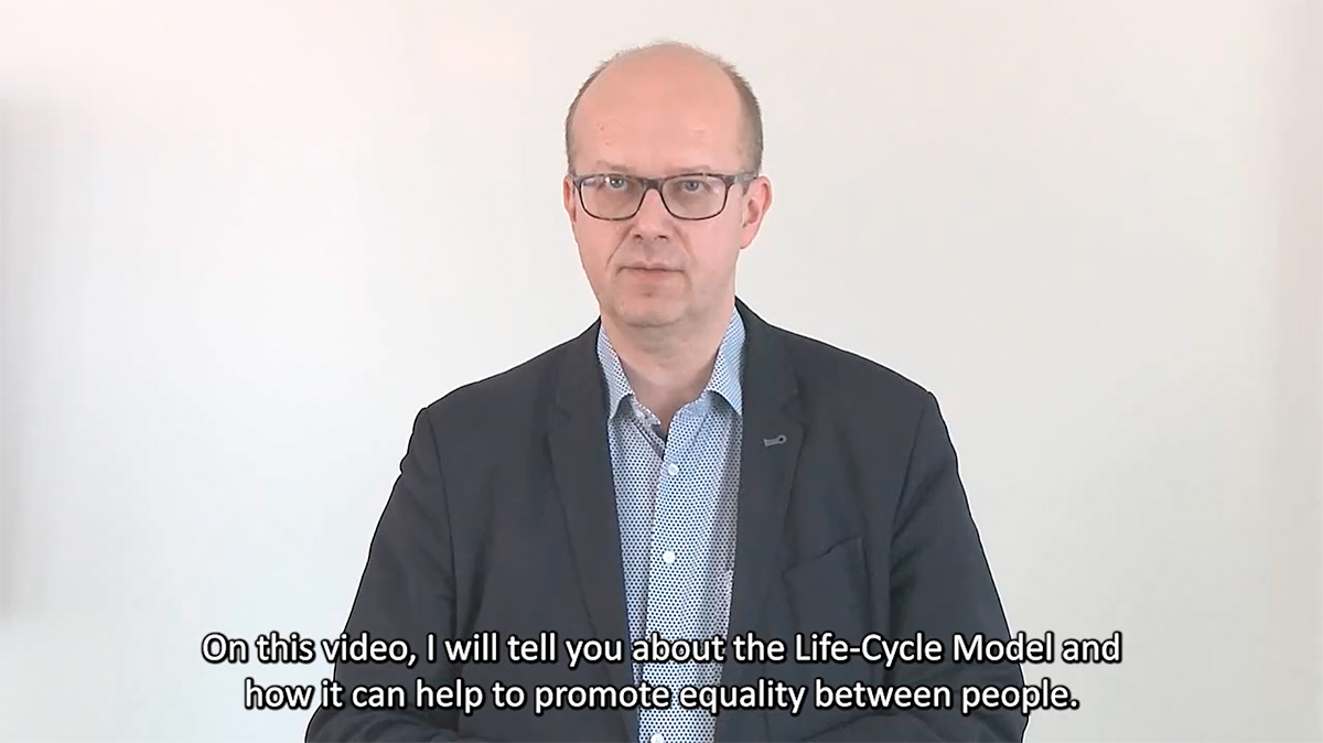 Screenshot from a video. Esa Iivonen says: On this video, I will tell you about the Life-Cycle Model and how it can help to promote equality between people.